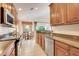 Modern kitchen featuring stainless steel appliances, granite countertops, and a view into the breakfast nook at 8374 Quimby Cir # 8374, Davenport, FL 33896
