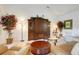 Bright living room with comfortable sofas, a glass coffee table, and a wooden entertainment center at 8374 Quimby Cir # 8374, Davenport, FL 33896