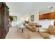 Open-concept living area with plush seating, a glass coffee table, and a view into the kitchen and dining room at 8374 Quimby Cir # 8374, Davenport, FL 33896