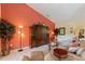 Bright living room showcasing an entertainment center, decorative plants and furniture at 8374 Quimby Cir # 8374, Davenport, FL 33896