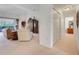 Spacious living room with plush seating, balcony access, and an open hallway to a bathroom and closets at 8374 Quimby Cir # 8374, Davenport, FL 33896
