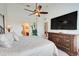 Spacious primary bedroom featuring a large dresser, vaulted ceiling, and ensuite bathroom for added privacy and convenience at 8374 Quimby Cir # 8374, Davenport, FL 33896