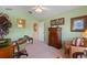 Bright home office featuring a wood desk and chair plus views of the home's interior at 8374 Quimby Cir # 8374, Davenport, FL 33896