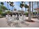 Outdoor lounge area with rocking chairs and surrounding landscaping at 8374 Quimby Cir # 8374, Davenport, FL 33896