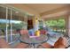Cozy screened patio with dining and lounging furniture, offering serene outdoor living space at 8374 Quimby Cir # 8374, Davenport, FL 33896