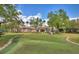 Beautiful putting green adjacent to community center, with manicured landscaping and American flag waving at 8374 Quimby Cir # 8374, Davenport, FL 33896