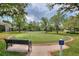 Well-maintained putting green surrounded by lush landscaping and mature trees at 8374 Quimby Cir # 8374, Davenport, FL 33896