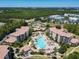 A gorgeous aerial view of this community with a pristine pool, landscaping, and beautiful buildings at 8774 Worldquest Blvd # 7503, Orlando, FL 32821