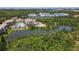 Wonderful view of this community from the air, showing the pool, lake, landscaping and surrounding forest at 8774 Worldquest Blvd # 7503, Orlando, FL 32821