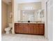 Bathroom features a granite-topped vanity with double sinks and ample storage space at 8774 Worldquest Blvd # 7503, Orlando, FL 32821