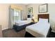 Comfortable bedroom features two beds, natural light and pleasant views at 8774 Worldquest Blvd # 7503, Orlando, FL 32821