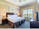 Relaxing bedroom featuring a comfortable king bed, soft lighting, and a large window with scenic water views at 8774 Worldquest Blvd # 7503, Orlando, FL 32821