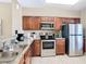Well-equipped kitchen with stainless steel appliances and granite countertops at 8774 Worldquest Blvd # 7503, Orlando, FL 32821