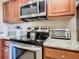 Cozy kitchen featuring granite countertops and stainless steel appliances at 8774 Worldquest Blvd # 7503, Orlando, FL 32821
