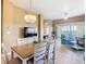 Open-concept living area with dining table and access to balcony at 8774 Worldquest Blvd # 7503, Orlando, FL 32821