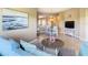 Inviting living room featuring an open layout, cozy seating, and a charming dining area with a view to the kitchen at 8774 Worldquest Blvd # 7503, Orlando, FL 32821