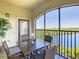 Inviting screened patio boasting comfortable seating, an arched enclosure, and a tranquil view of the lake and nature at 8774 Worldquest Blvd # 7503, Orlando, FL 32821