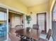 Relaxing screened patio with comfortable seating, table, and an inviting view of the surrounding landscape, sliding door entry at 8774 Worldquest Blvd # 7503, Orlando, FL 32821