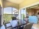 Relaxing outdoor patio with screened enclosure, stylish wicker chairs, and a table perfect for enjoying the serene outdoor view at 8774 Worldquest Blvd # 7503, Orlando, FL 32821