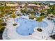 Expansive community pool with palm trees and lounge seating areas, perfect for relaxing and socializing at 8943 Amelia Downs Trl, Kissimmee, FL 34747