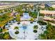 Lush landscaping surrounds water activities with outdoor seating, a playground, and a flowrider area in the community at 8943 Amelia Downs Trl, Kissimmee, FL 34747