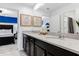 Spacious bathroom featuring double sinks, large mirror, and dark cabinets at 8943 Amelia Downs Trl, Kissimmee, FL 34747