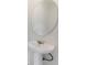 Stylish bathroom features a pedestal sink, round mirror, and sleek fixtures at 8943 Amelia Downs Trl, Kissimmee, FL 34747