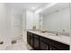 Double sink bathroom with dark wooden cabinets, with white walls and tile flooring at 8943 Amelia Downs Trl, Kissimmee, FL 34747