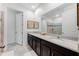 Bathroom boasts a double vanity, quartz countertops, dark cabinets, and modern fixtures at 8943 Amelia Downs Trl, Kissimmee, FL 34747