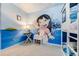 Themed bedroom featuring custom mural and bunk beds with colorful bedding at 8943 Amelia Downs Trl, Kissimmee, FL 34747