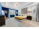 Bright bedroom with blue accent wall, tray ceiling, and comfortable furnishings offers a cozy retreat at 8943 Amelia Downs Trl, Kissimmee, FL 34747