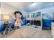 Themed bedroom featuring custom mural and bunk beds with colorful bedding at 8943 Amelia Downs Trl, Kissimmee, FL 34747