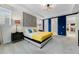 Bright bedroom with blue accent wall, tray ceiling, and comfortable furnishings offers a cozy retreat at 8943 Amelia Downs Trl, Kissimmee, FL 34747