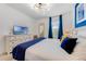 Bright bedroom with blue accent wall, tray ceiling, and comfortable furnishings offers a cozy retreat at 8943 Amelia Downs Trl, Kissimmee, FL 34747