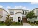 Charming two-story home featuring a well-manicured lawn, stone accents, and a cozy front porch at 8943 Amelia Downs Trl, Kissimmee, FL 34747