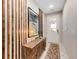 Bright foyer with decorative wooden wall accents, stylish furniture, and a view of the front door at 8943 Amelia Downs Trl, Kissimmee, FL 34747