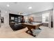 Entertainment room with a pool table, arcade games, and comfortable seating, perfect for leisure and relaxation at 8943 Amelia Downs Trl, Kissimmee, FL 34747