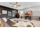 Game room featuring a comfortable seating area, gaming consoles, and stylish wall decor for entertainment at 8943 Amelia Downs Trl, Kissimmee, FL 34747