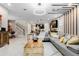 Open-concept living room with stylish decor, modern lighting, and seamless flow into the dining and kitchen areas at 8943 Amelia Downs Trl, Kissimmee, FL 34747