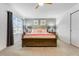 Bedroom with a wooden sleigh bed with coral accents and a window allowing ample light at 8943 Amelia Downs Trl, Kissimmee, FL 34747