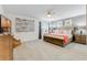 Bright bedroom with large bed, two nightstands, and serene artwork adds elegance at 8943 Amelia Downs Trl, Kissimmee, FL 34747
