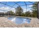 A screened-in pool area offers an outdoor entertainment option and a place to cool off at 8943 Amelia Downs Trl, Kissimmee, FL 34747