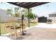 Outdoor patio with modern chairs and grill offers a relaxing space for outdoor gatherings and enjoyment at 9016 Pyrus St, Kissimmee, FL 34747