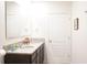 Bathroom includes a double vanity with granite countertops and a white framed mirror at 9016 Pyrus St, Kissimmee, FL 34747