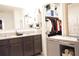 Well-lit bathroom featuring double sinks, granite countertops, and a walk-in closet at 9016 Pyrus St, Kissimmee, FL 34747