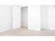 Empty bedroom with neutral carpet and bright white walls featuring a closet with shelves at 9016 Pyrus St, Kissimmee, FL 34747