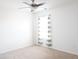 Bright bedroom featuring neutral carpet, a modern ceiling fan and a window with patterned curtains at 9016 Pyrus St, Kissimmee, FL 34747