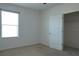 An empty bedroom features neutral carpet and a closet at 9016 Pyrus St, Kissimmee, FL 34747