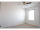 A sunlit room features neutral carpeting and a ceiling fan at 9016 Pyrus St, Kissimmee, FL 34747