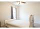 Bedroom features a ceiling fan and carpeted floors and bright natural lighting at 9016 Pyrus St, Kissimmee, FL 34747